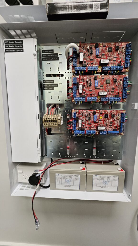 Reader expanders installed with labelled doors in an access control cabinet