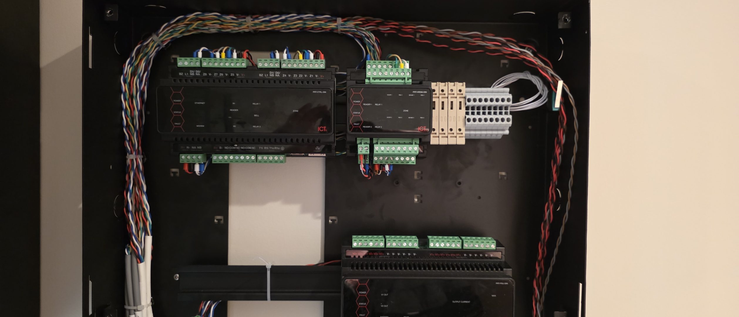 Professional electrical control panel with organized wiring, terminal blocks, and automation components